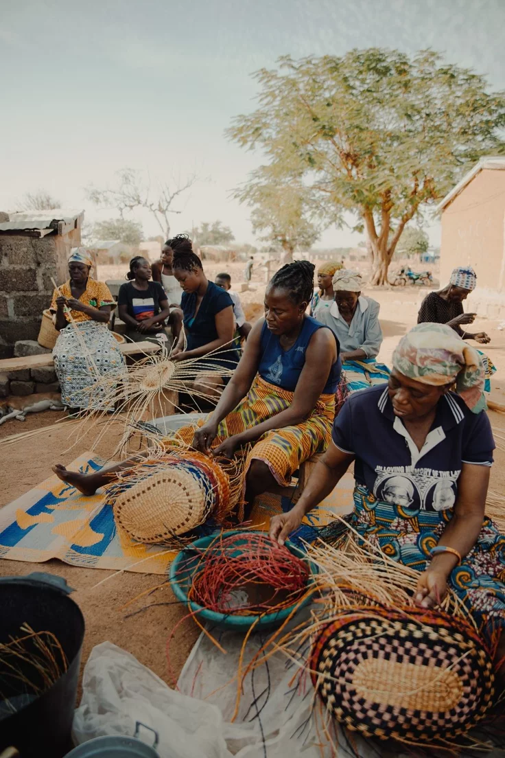 Women weaving baskets at gathering