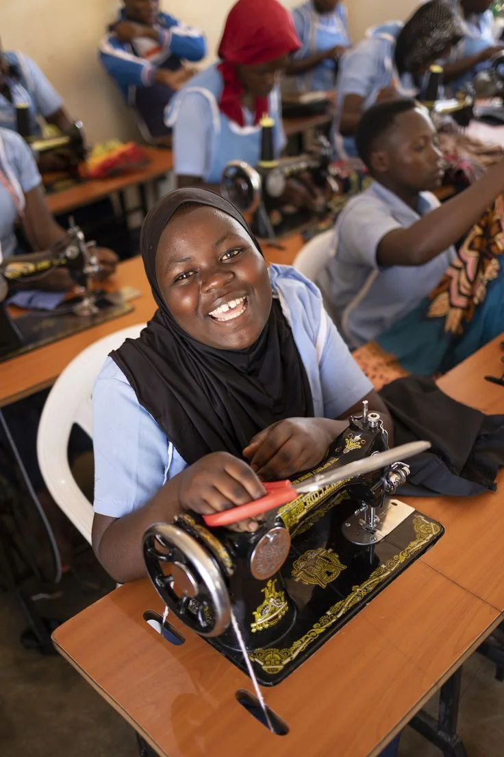 Young woman at sewing machine in vocational training