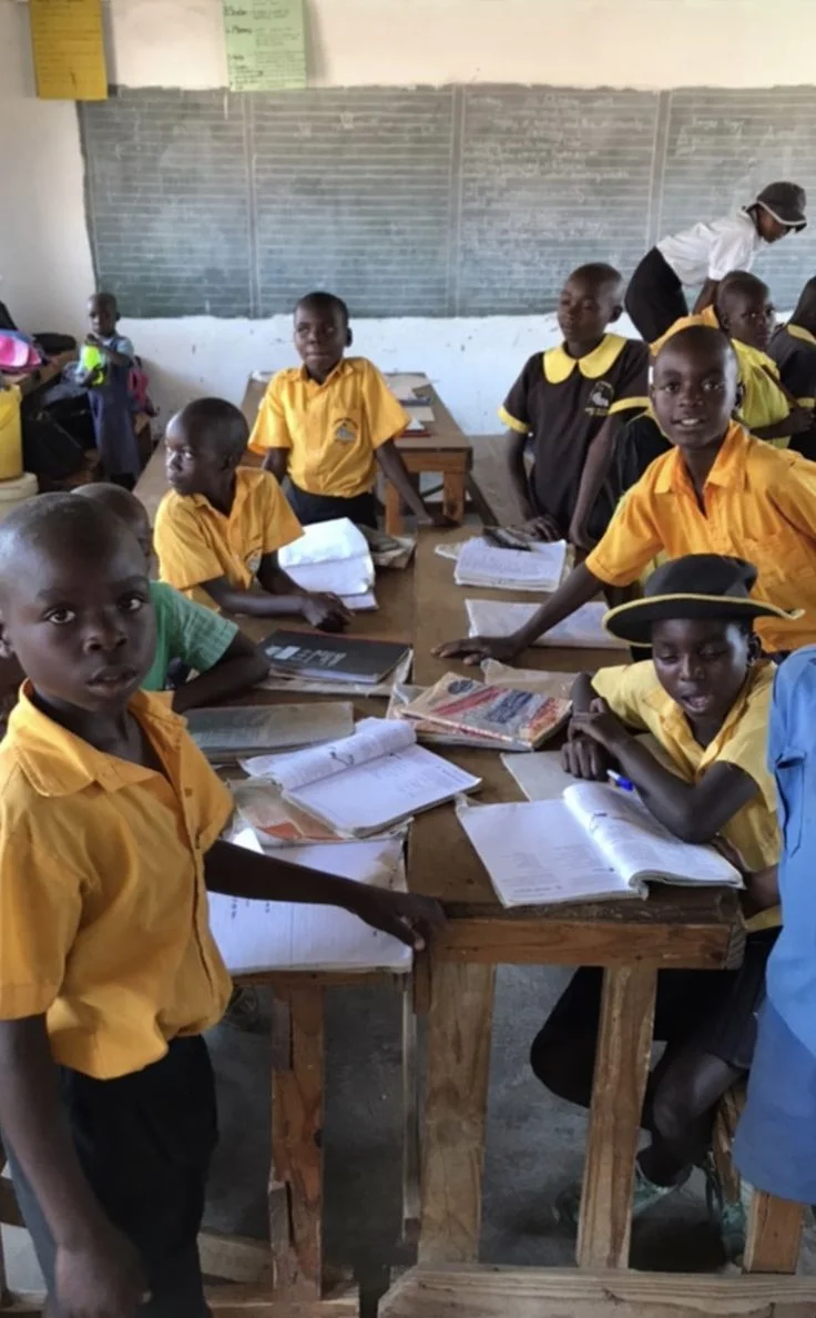 Children in uniforms studying in classroom