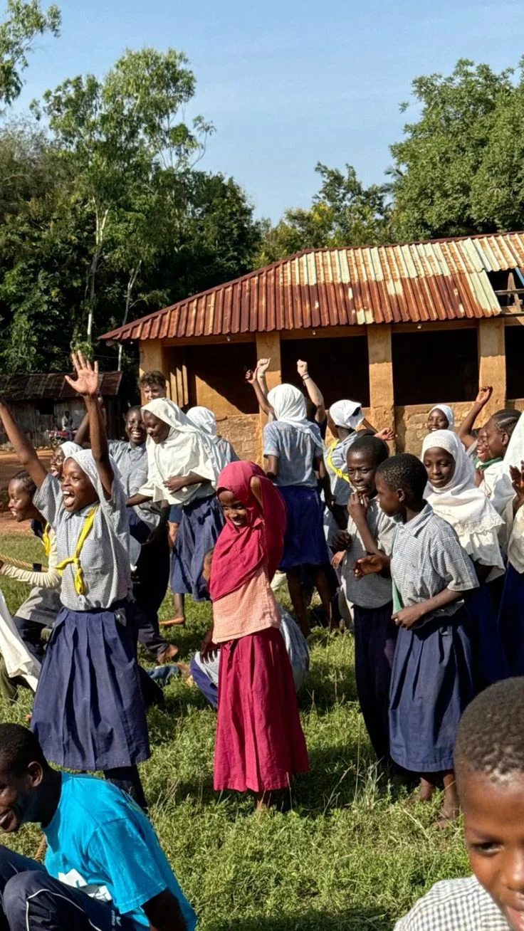 Large group celebrating outside rural building