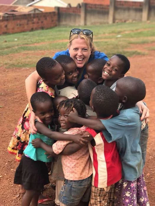 Volunteer hugging children