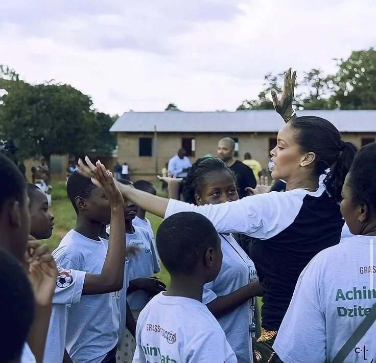Volunteer planting trees with children